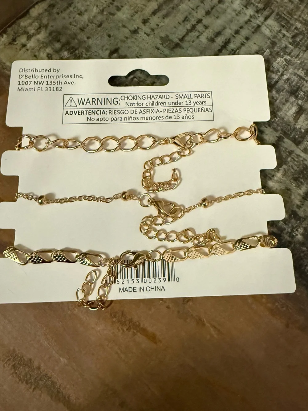 Set of 3 D’Bello packaged gold toned bracelets.